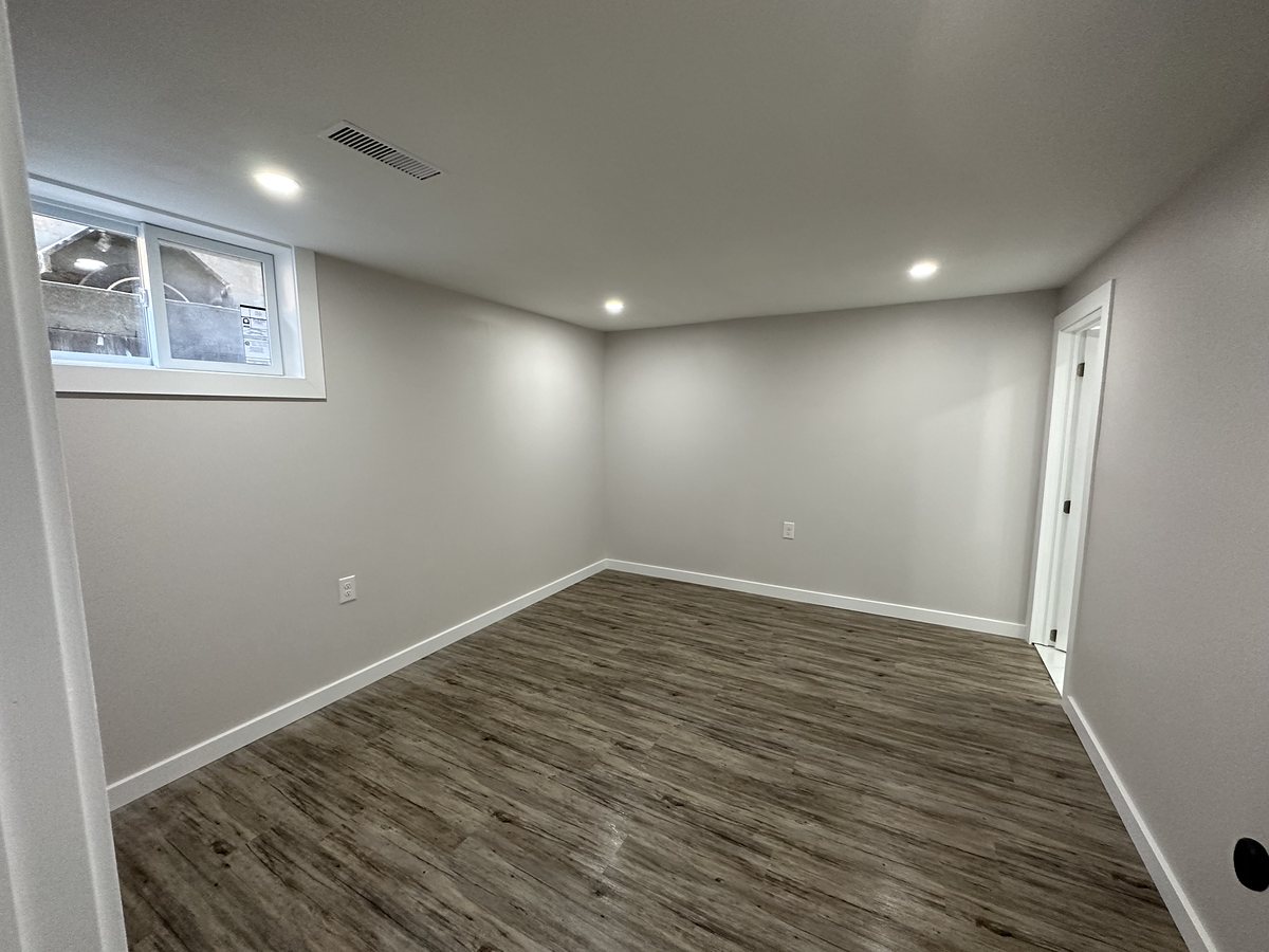 Finished basement corner with an egress window