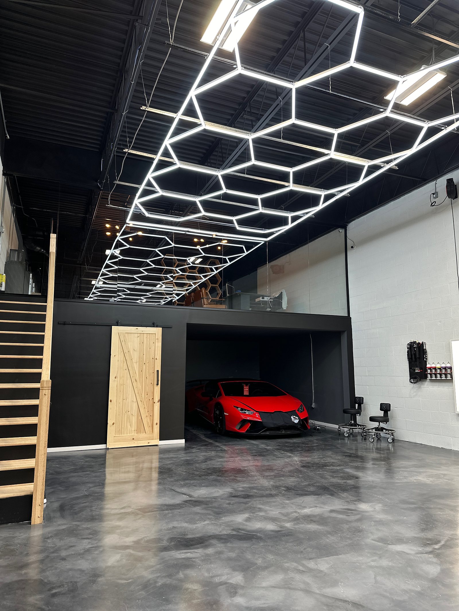 Finished commercial workshop with hexagon LED ceiling lighting and a polished concrete floor
