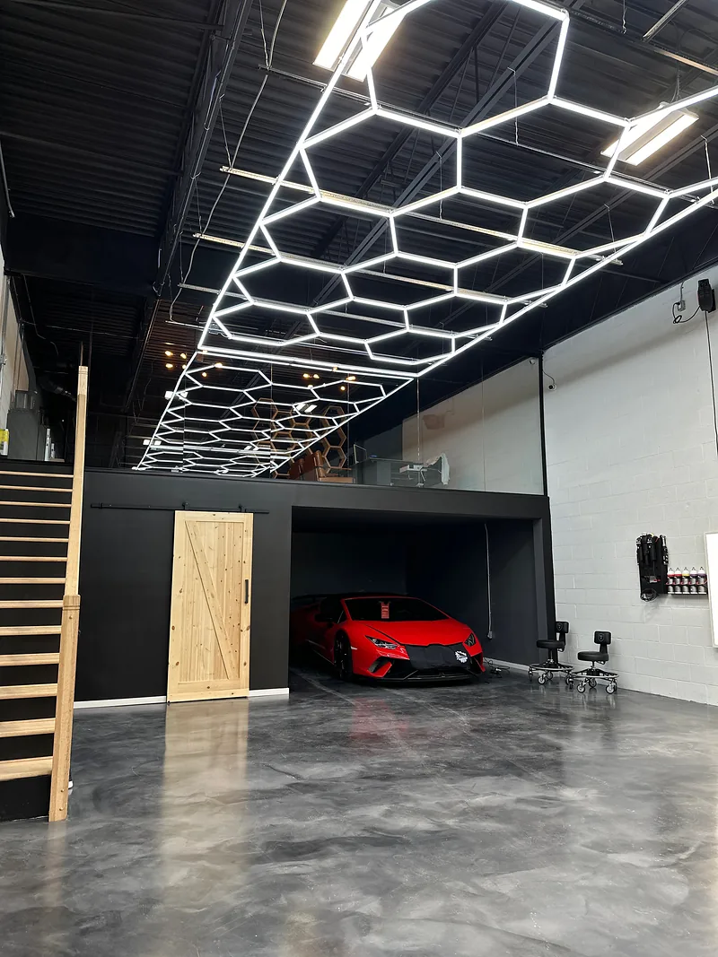 Finished commercial workshop with hexagon LED ceiling lighting and a polished concrete floor
