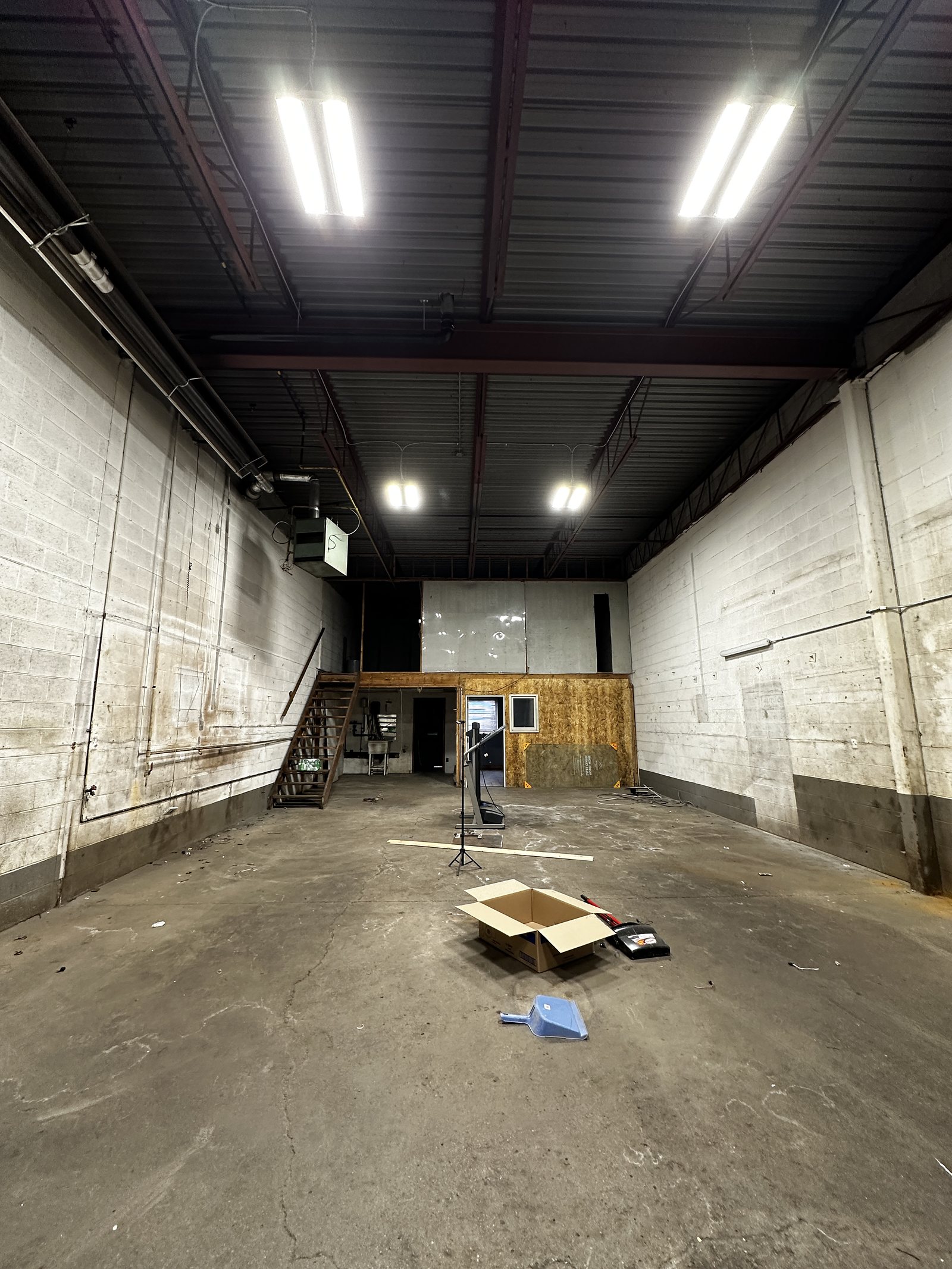 Bare commercial unit before fit-out: exposed block walls and concrete floor