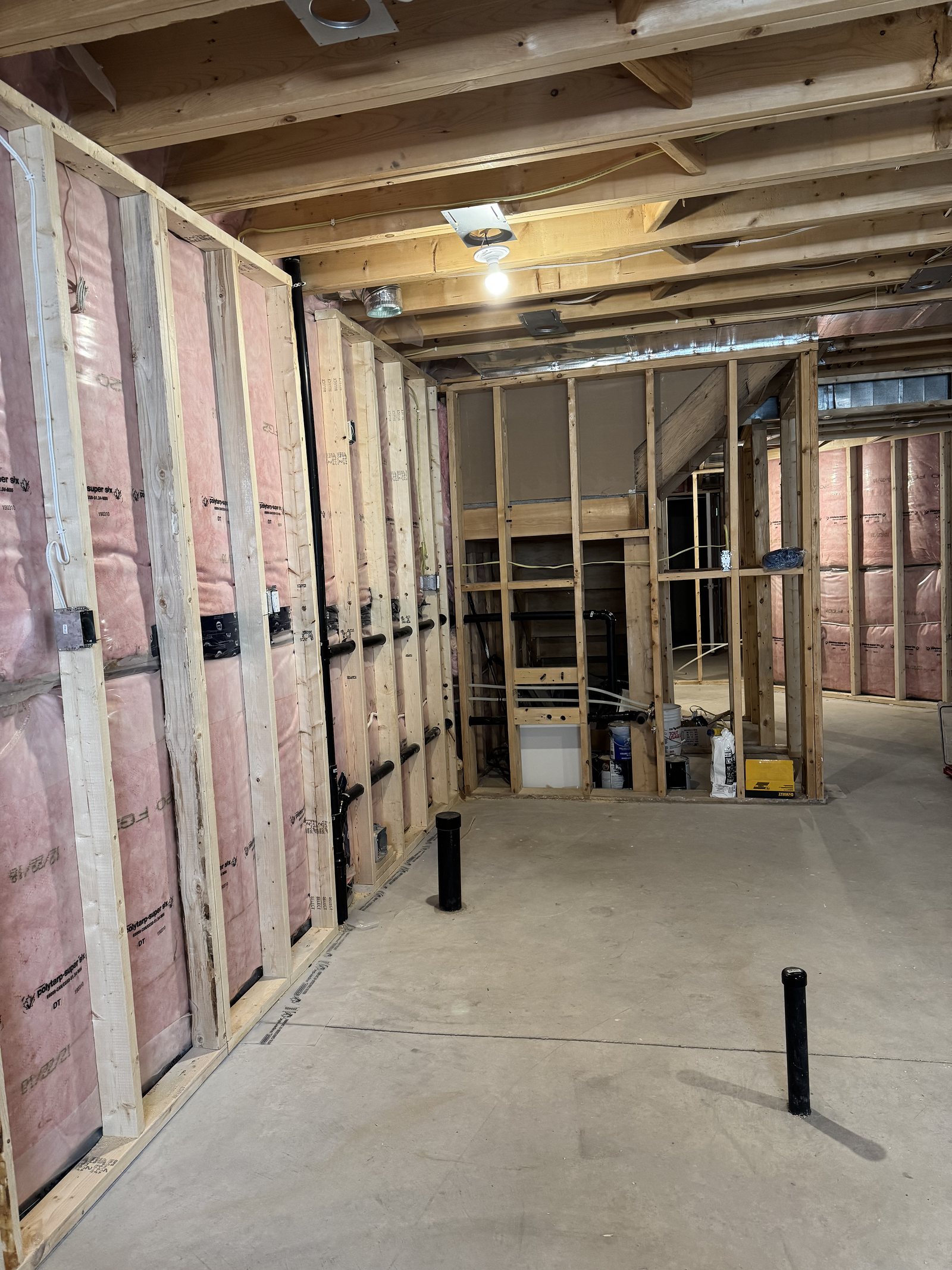 Basement during construction: stud framing, insulation and rough-in services